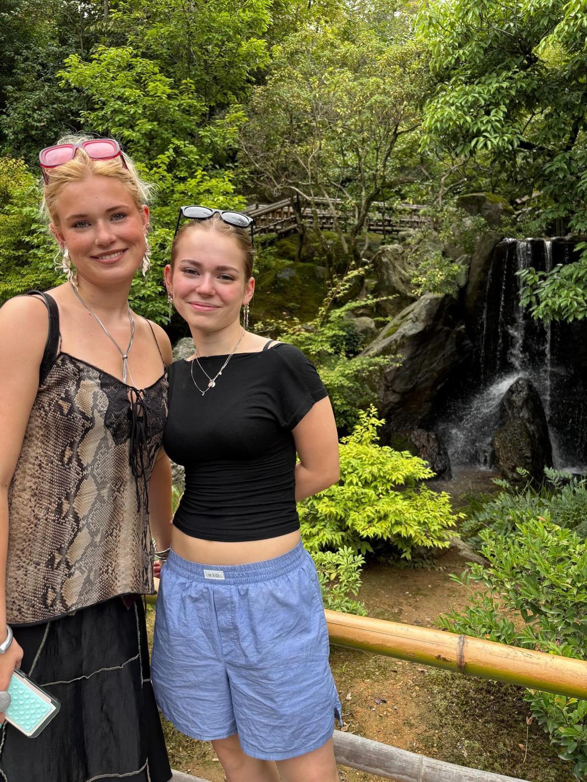 Guests by a waterfall in a Kyoto garden